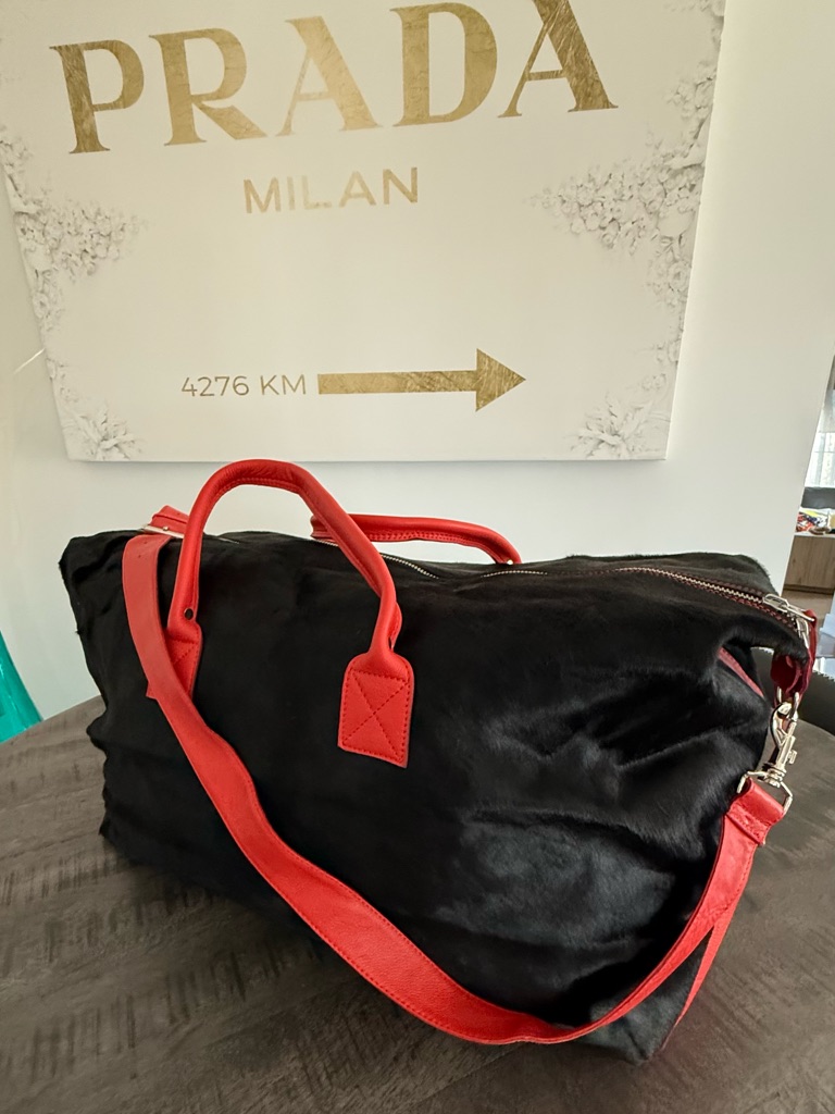 Black Duffel Bag With Red Handles And Strap